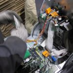 Technician removing parts from a computer