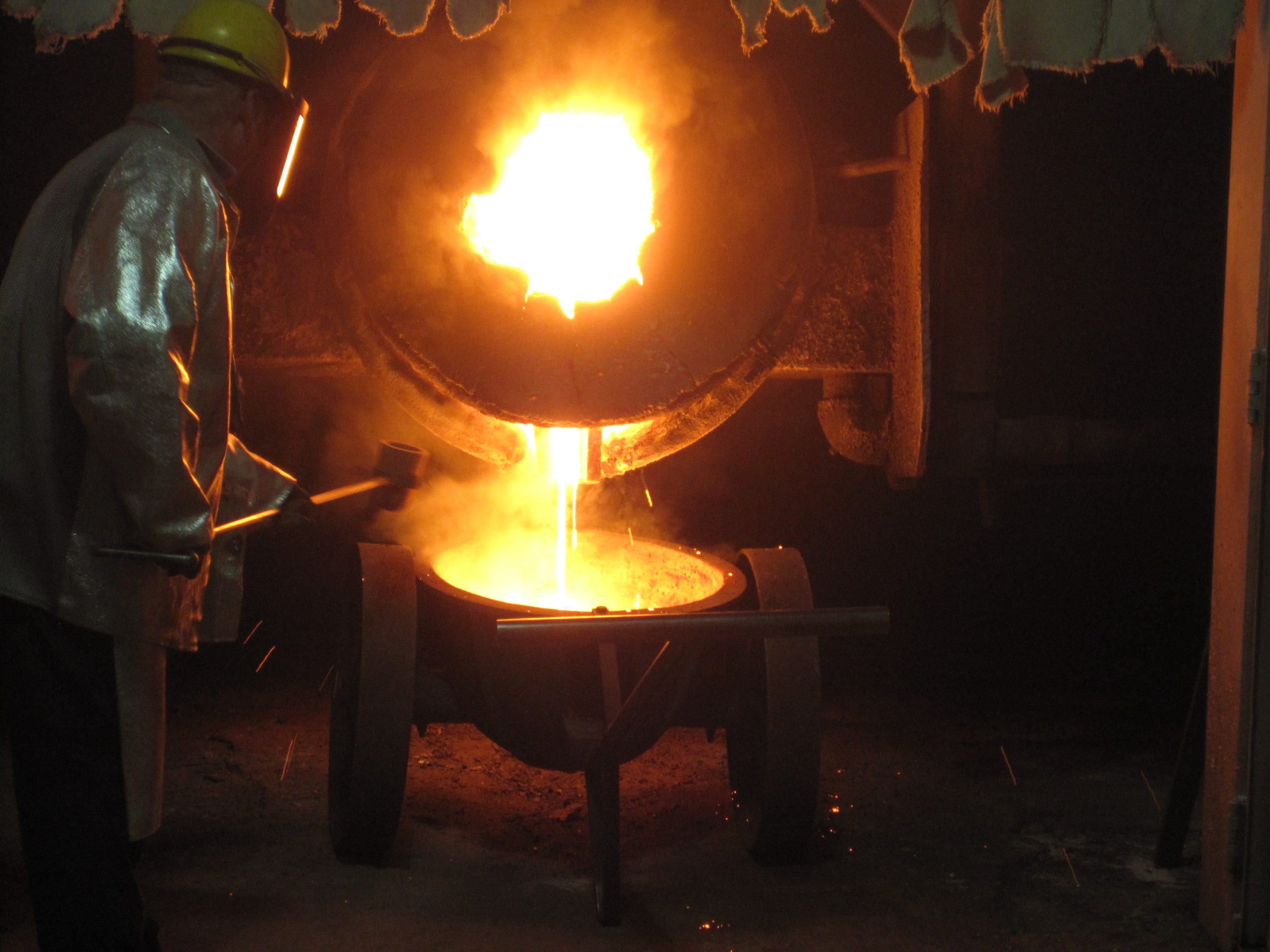 Molten metal being poured from a crucible