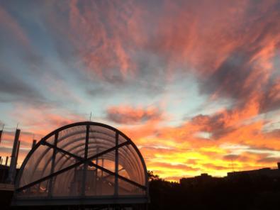 An orange and red sunset behind the chamber