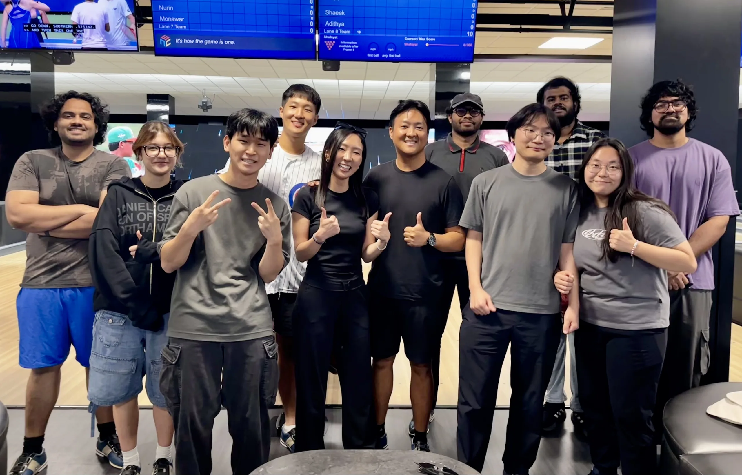 Group of students posing in front of a bowling lane