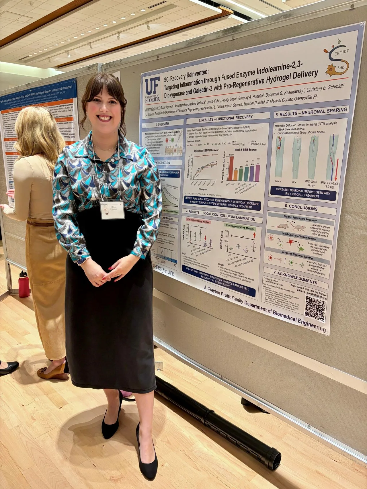 Grad student Allison Campbell-Galbraith next to her research poster